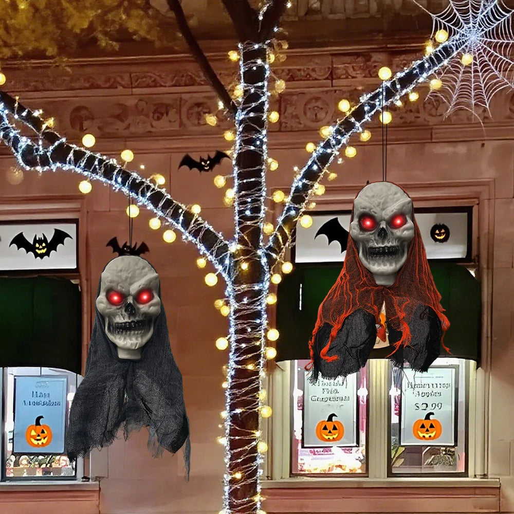Two skull ghosts styled around a lit tree