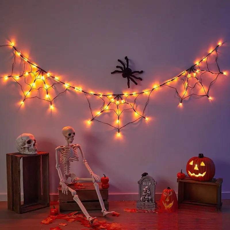 Orange spider web garland above a skeleton display